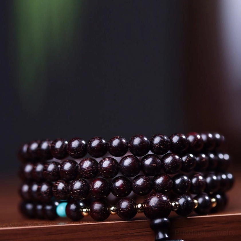 Red sandalwood mala bracelet full view showing all 108 beads with lotus pendant and adjustable tassel