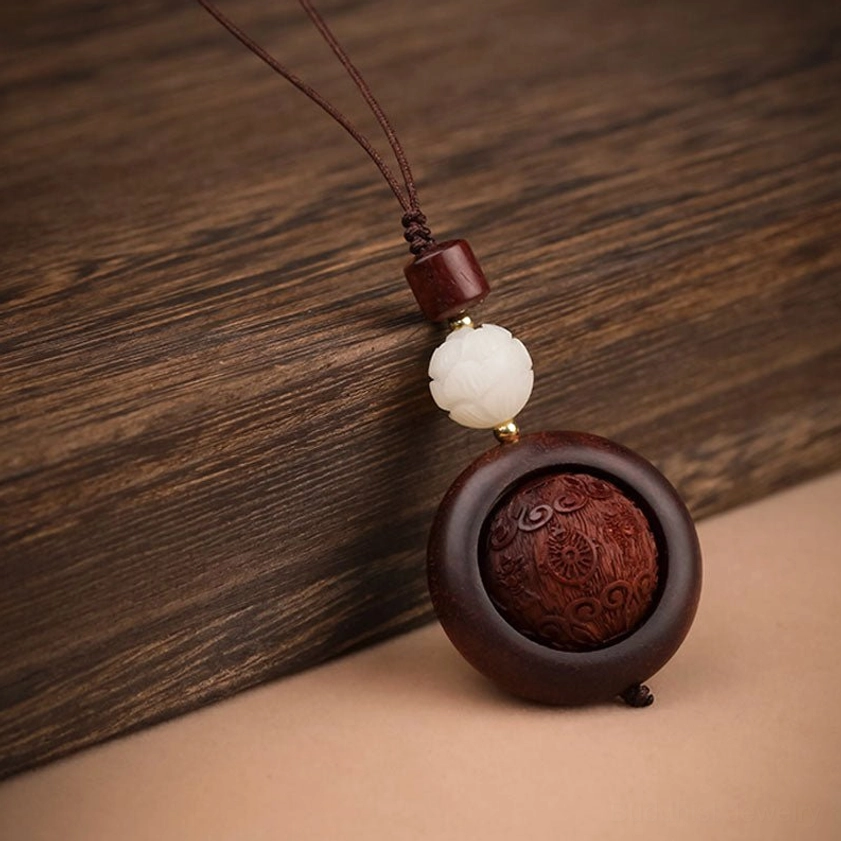 Red sandalwood prayer keychain featuring auspicious symbol combined with lotus flower carved design