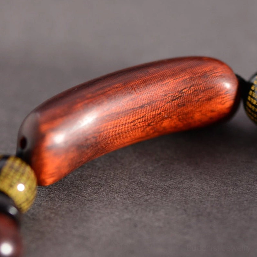 Detailed view of sandalwood beads with metal spacer accents and wood grain texture