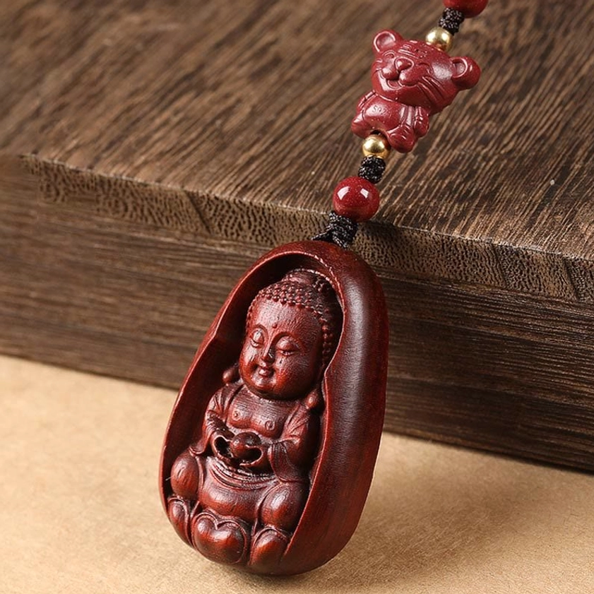 Red sandalwood zodiac Buddha keychain showing braided cord attachment and pendant detail