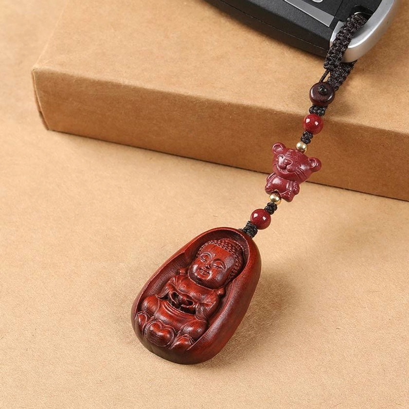 Red sandalwood Buddha zodiac keychain with cinnabar bead showing traditional carving and natural wood finish