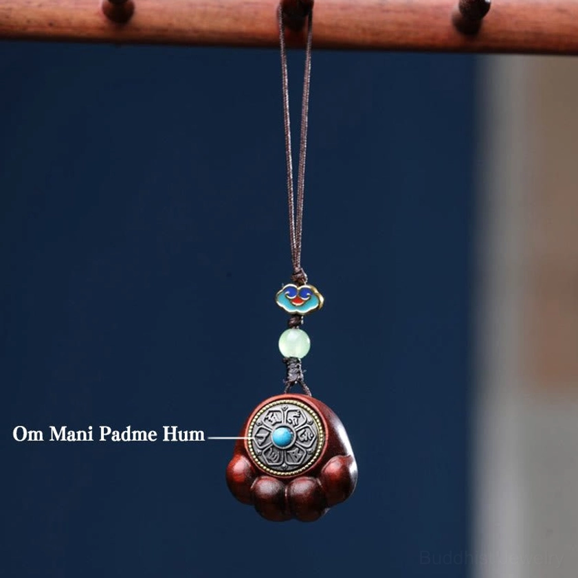 Red sandalwood cat paw hanging ornament with Om Mani Padme Hum mantra engraving and decorative beads on wooden stand