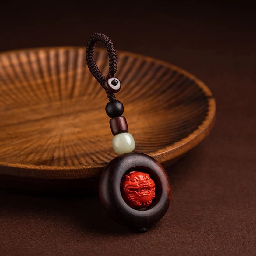 Red sandalwood and cinnabar Buddhist keychain showing natural material texture and handcrafted quality