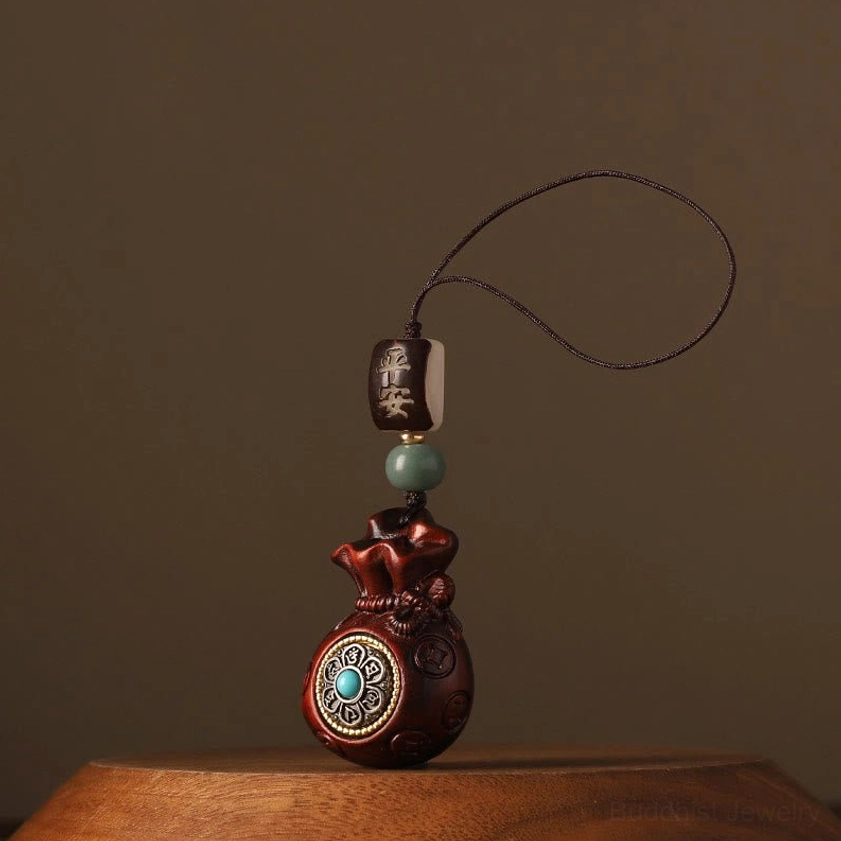 Red sandalwood money bag Buddhist pendant with compact size and short hanging loop, rotatable front charm detail