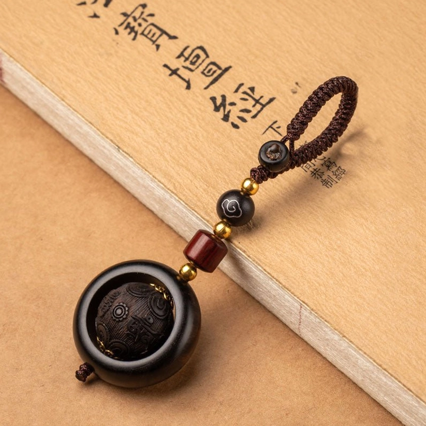 Red sandalwood and ebony prayer keychain with six true words Buddhist mantra carved design