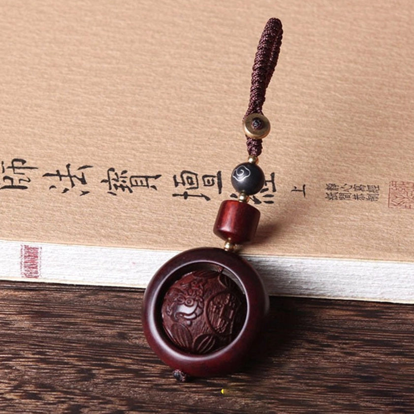 Red sandalwood prayer keychain with fortune character design and traditional Buddhist carving style