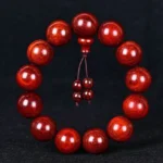Red sandalwood mala bracelet with single strand design and decorative tassel, handmade Buddhist prayer beads