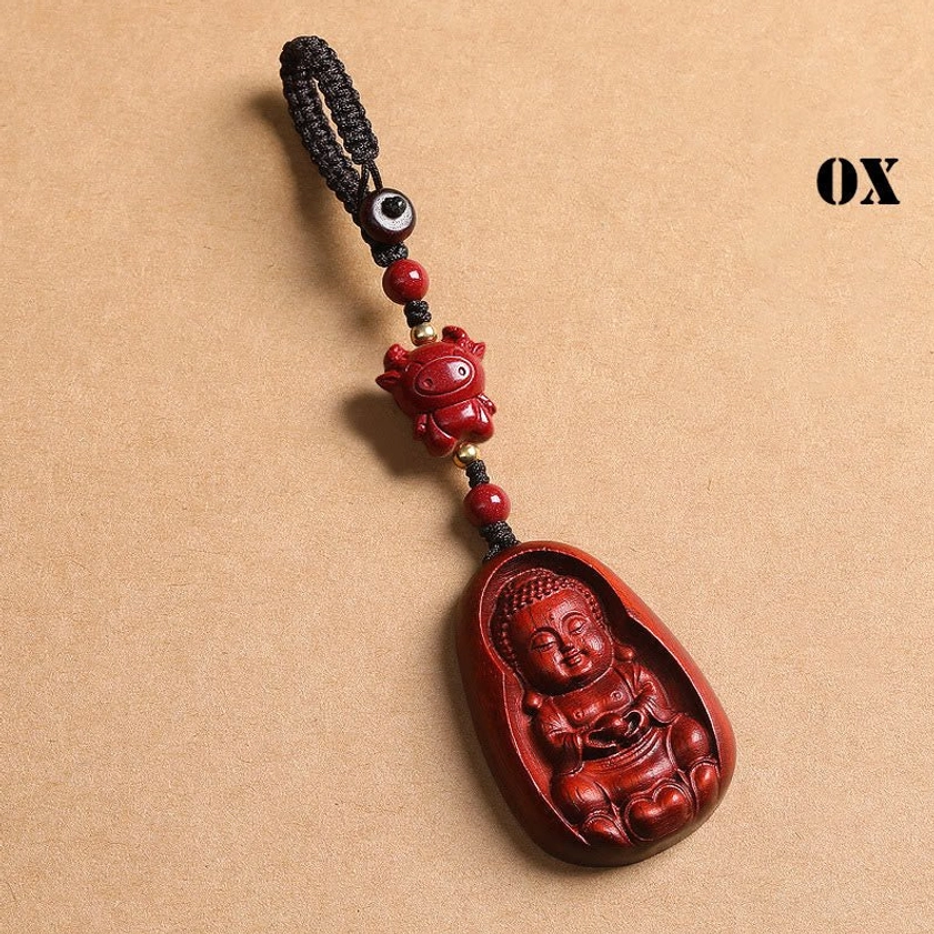 Red sandalwood Ox zodiac Buddha keychain front view on kraft paper with OX label and red carved animal bead