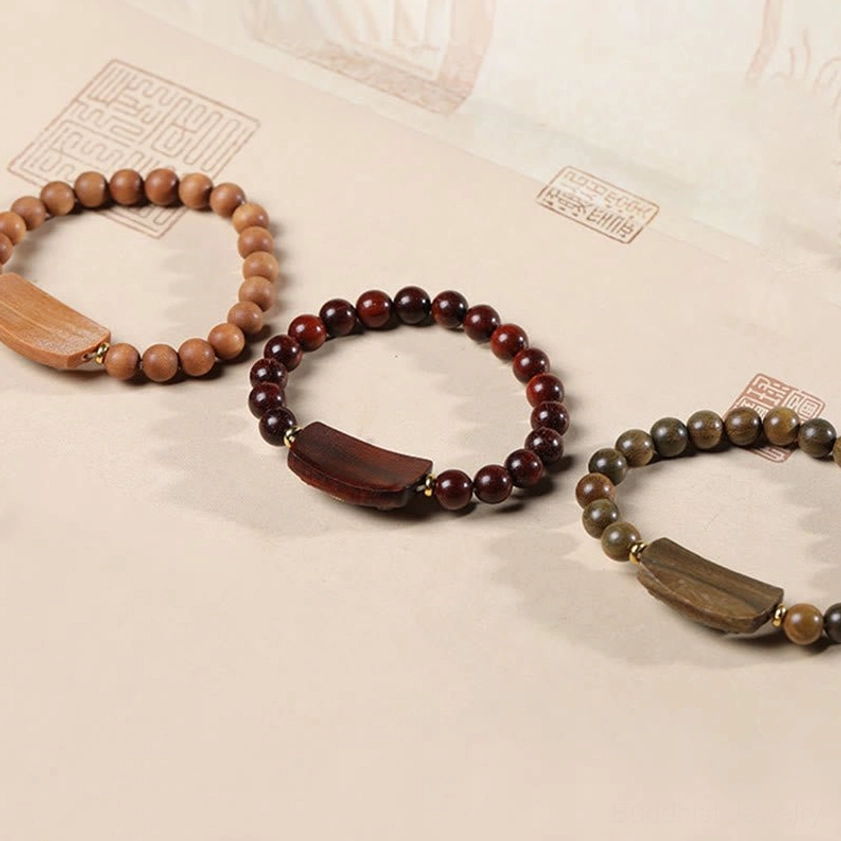 Red sandalwood peace bracelet with traditional seal stamp, authentic handcrafted presentation