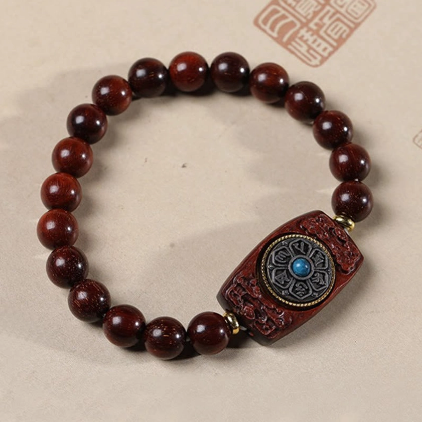 Small leaf red sandalwood Buddhist bracelet with rectangular charm carved with six true words pattern and blue inlay, full flat lay