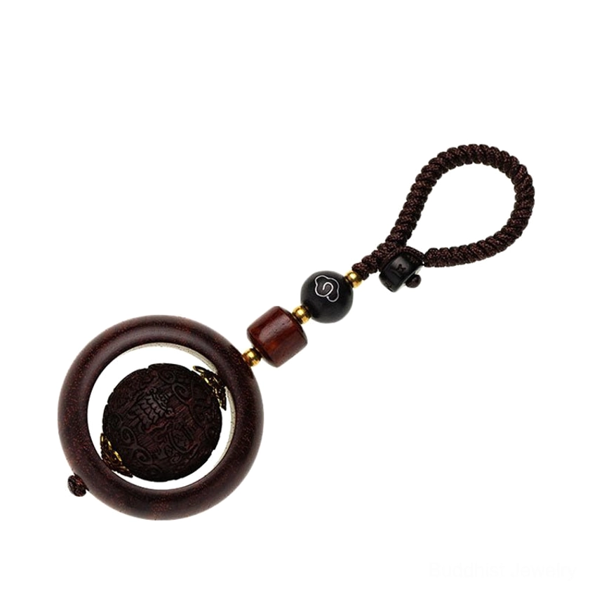 Collection of red sandalwood prayer keychains showing multiple Buddhist carving designs and handmade variations