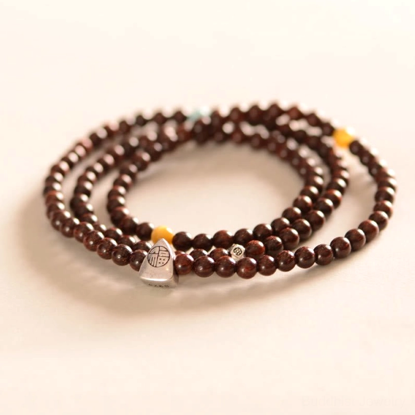 Dark red sandalwood beads triple wrap bracelet with Fu character pendant flat lay photography