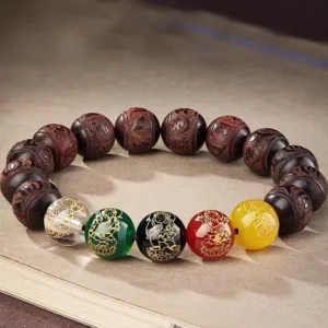 Five Directions Wealth God red sandalwood bracelet with multicolored gemstone beads displayed on vintage book surface