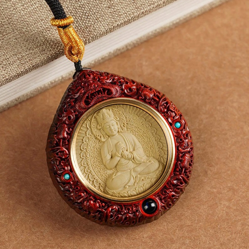 Red sandalwood zodiac natal Buddha necklace pendant with turquoise inlay, displayed on linen fabric