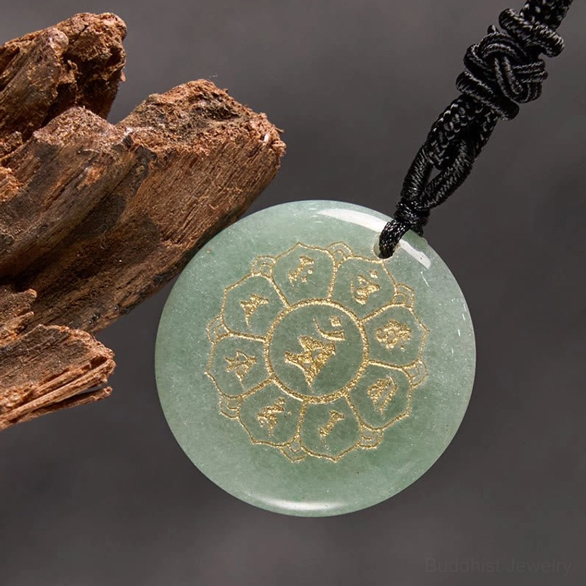 Red Stone Buddhist pendant featuring Om Mani Padme Hum mantra with gold Sanskrit design and black cord