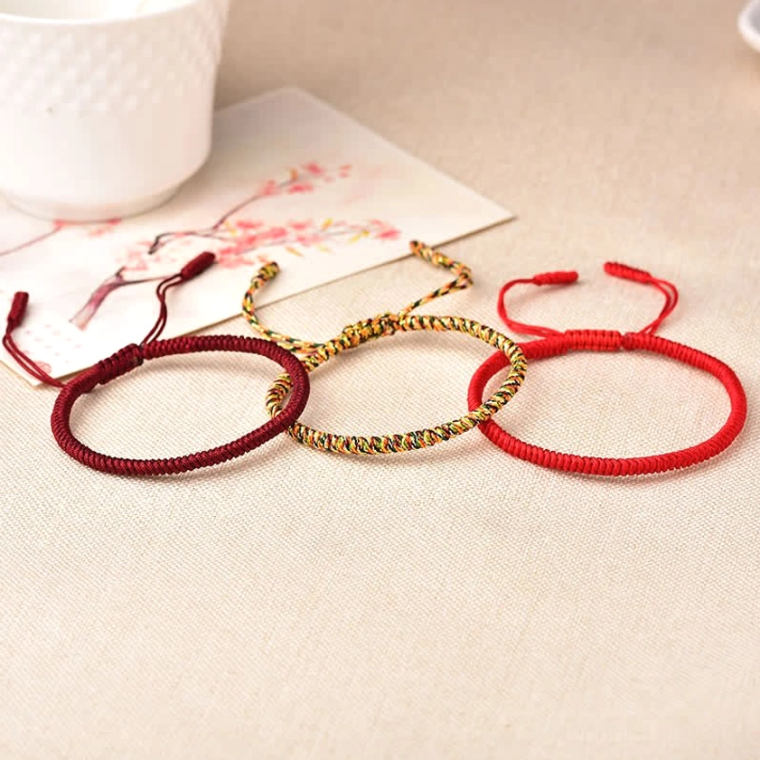 Adjustable Buddhist protection bracelets in wine red, pure red, and golden mixed tones displayed with mindfulness styling