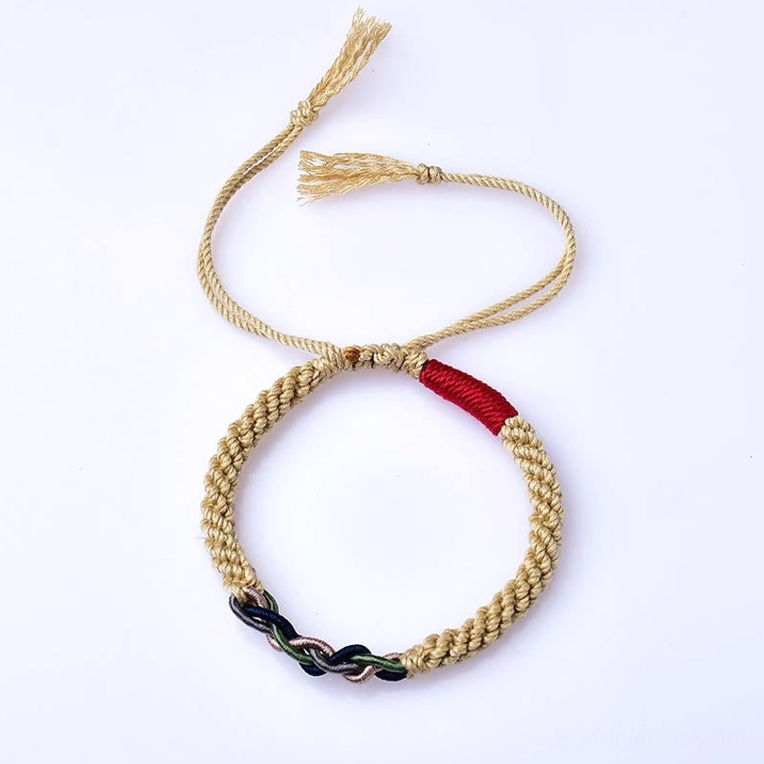 Front top-down view of hand-woven Buddhist red string bracelet with beige braided design and red accent strap on white background