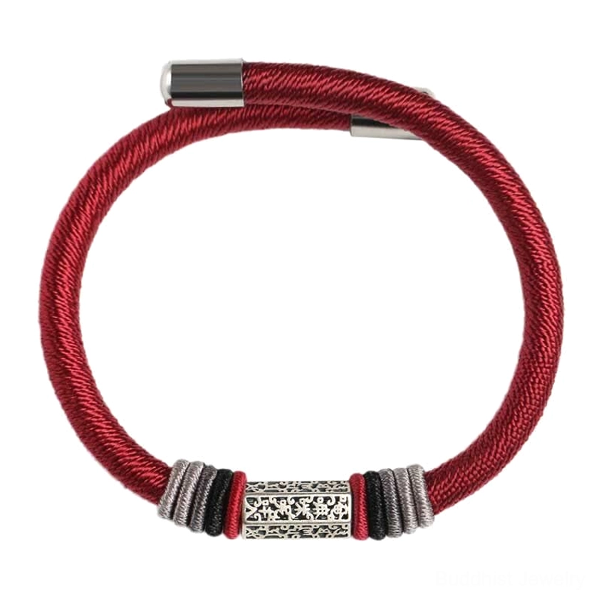 Full view of red Buddhist string bracelet with engraved silver center bead and polished metal end caps