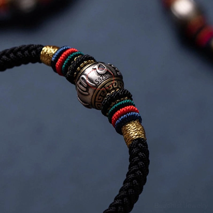 Red string Buddhist bracelet with 925 sterling silver luck charm and traditional King Kong knot amulet design
