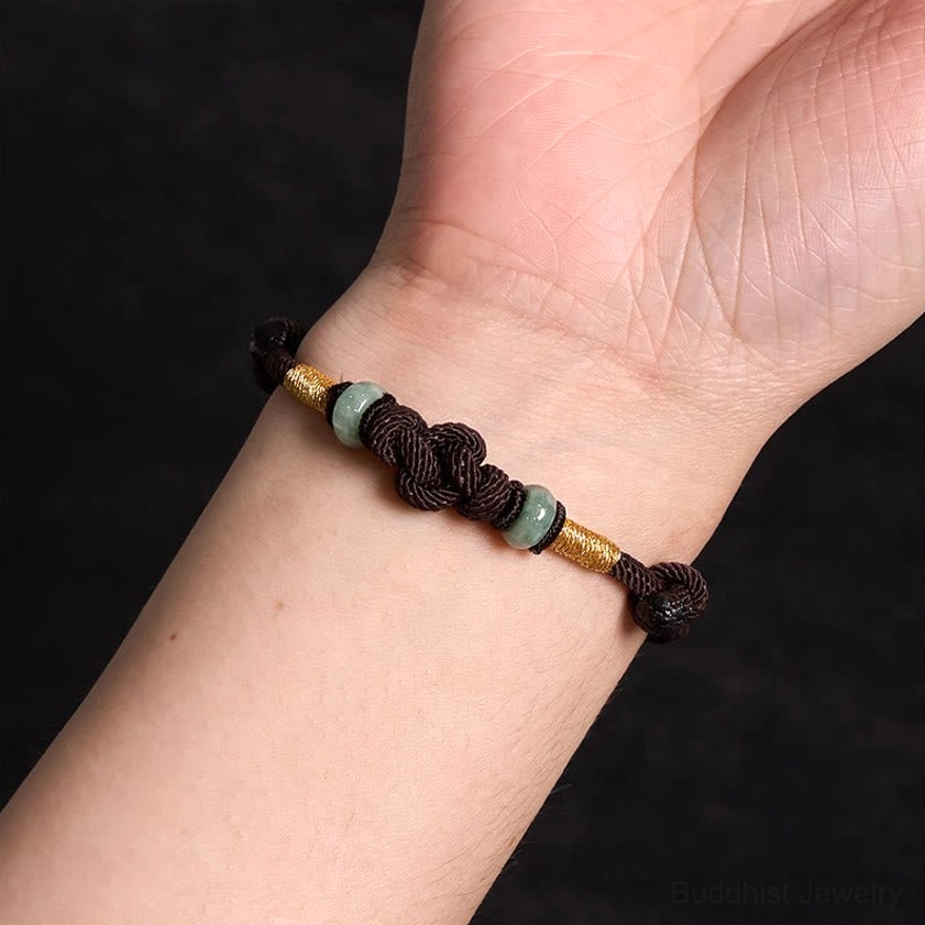Red string fortune knot jade bracelet showing intricate braided design representing destiny and connection