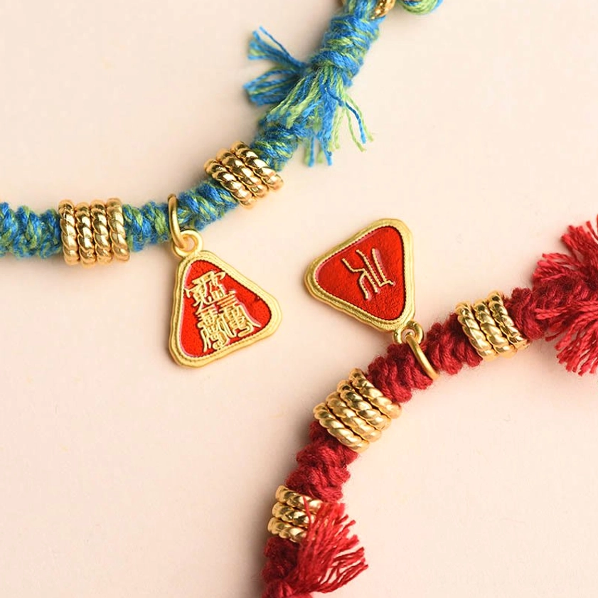 Red string protection bracelet complete product shot showing goddess charm pendant, adjustable braided cord, and flower tassel detail