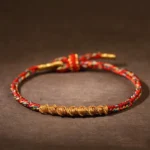 Red Buddhist Zodiac Natal Buddha Braided Rope Bracelet with Golden Twisted Weave and Adjustable Knot Closure