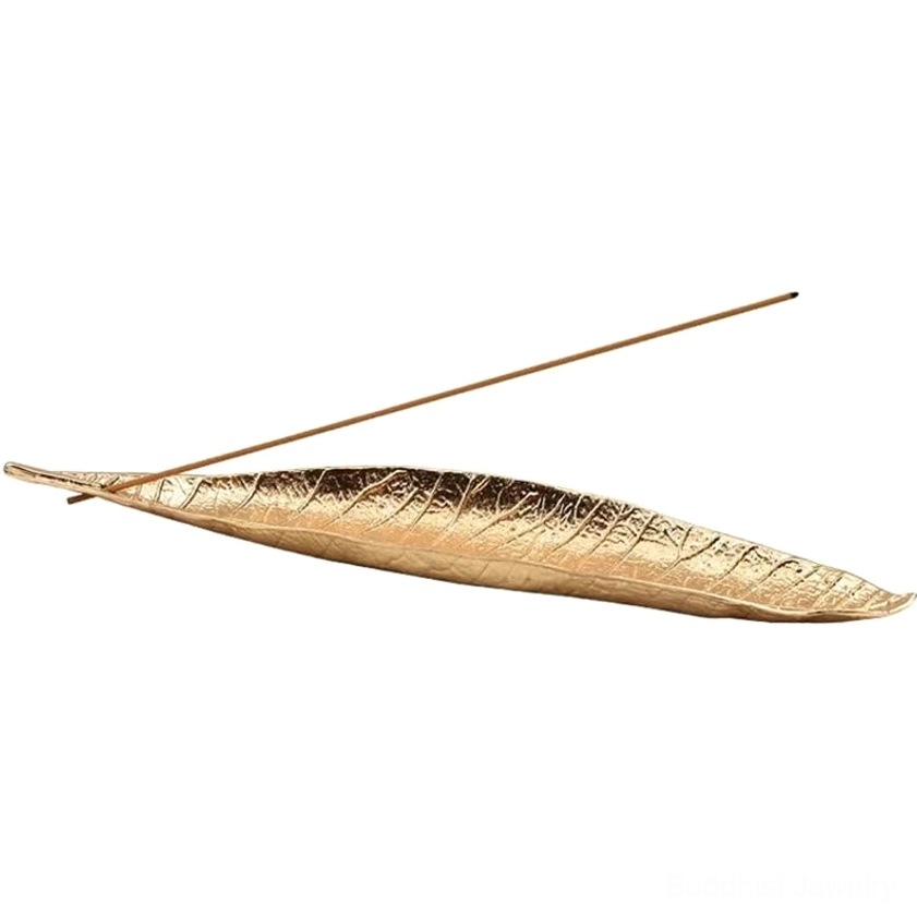 Reddish-brown handcrafted leaf incense burner holding incense stick detail shot with vein texture