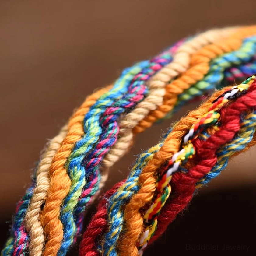 Handwoven multicolor braided rope texture showcasing the reincarnation knot weaving technique used in this Buddhist protection bracelet