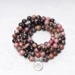 108 Rhodonite Mala Beads Bracelet with Silver Lotus Charm - Top-Down Close-Up View