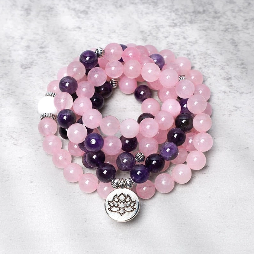 Natural rose quartz mala beads with amethyst stones and silver lotus charm bracelet - flat lay