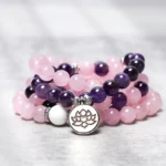 Rose quartz and amethyst 108 mala bracelet with silver lotus pendant - overhead studio view