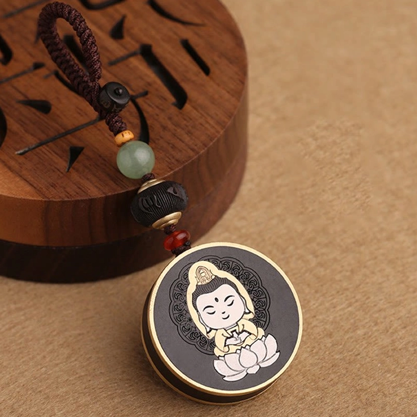 Rosewood Guanyin Bodhisattva keychain with polished metal border - handcrafted spiritual accessory