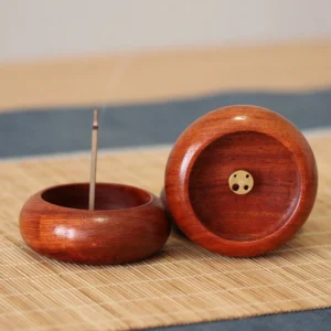 Handcrafted rosewood incense burner with brass insert holder, front view displaying natural wood grain texture and single incense stick