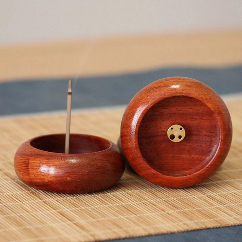 Handcrafted rosewood incense burner with brass insert holder, front view displaying natural wood grain texture and single incense stick