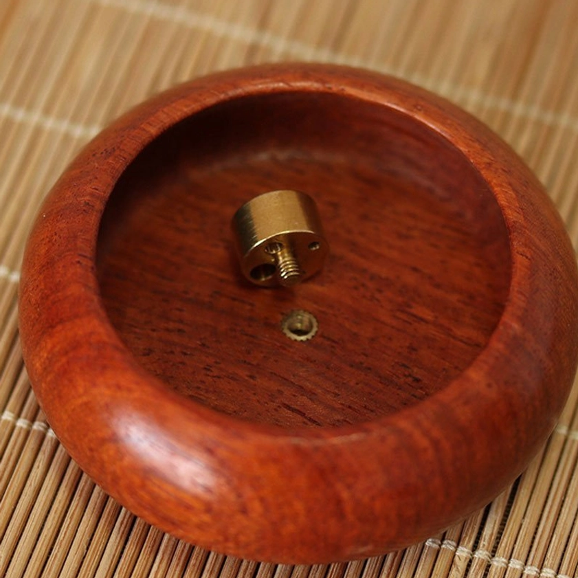 Close-up detail of removable brass incense insert base for rosewood incense holder, showing metal fixture design