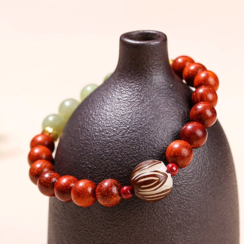 Authentic Buddhist prayer bracelet combining rosewood for warmth and cyan jade for balance and spiritual growth
