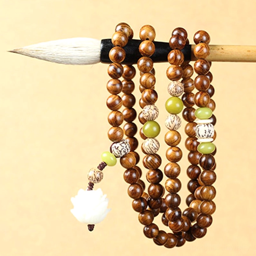Multiple rosewood mala bracelet strands with consistent decorative accents and lotus charm details