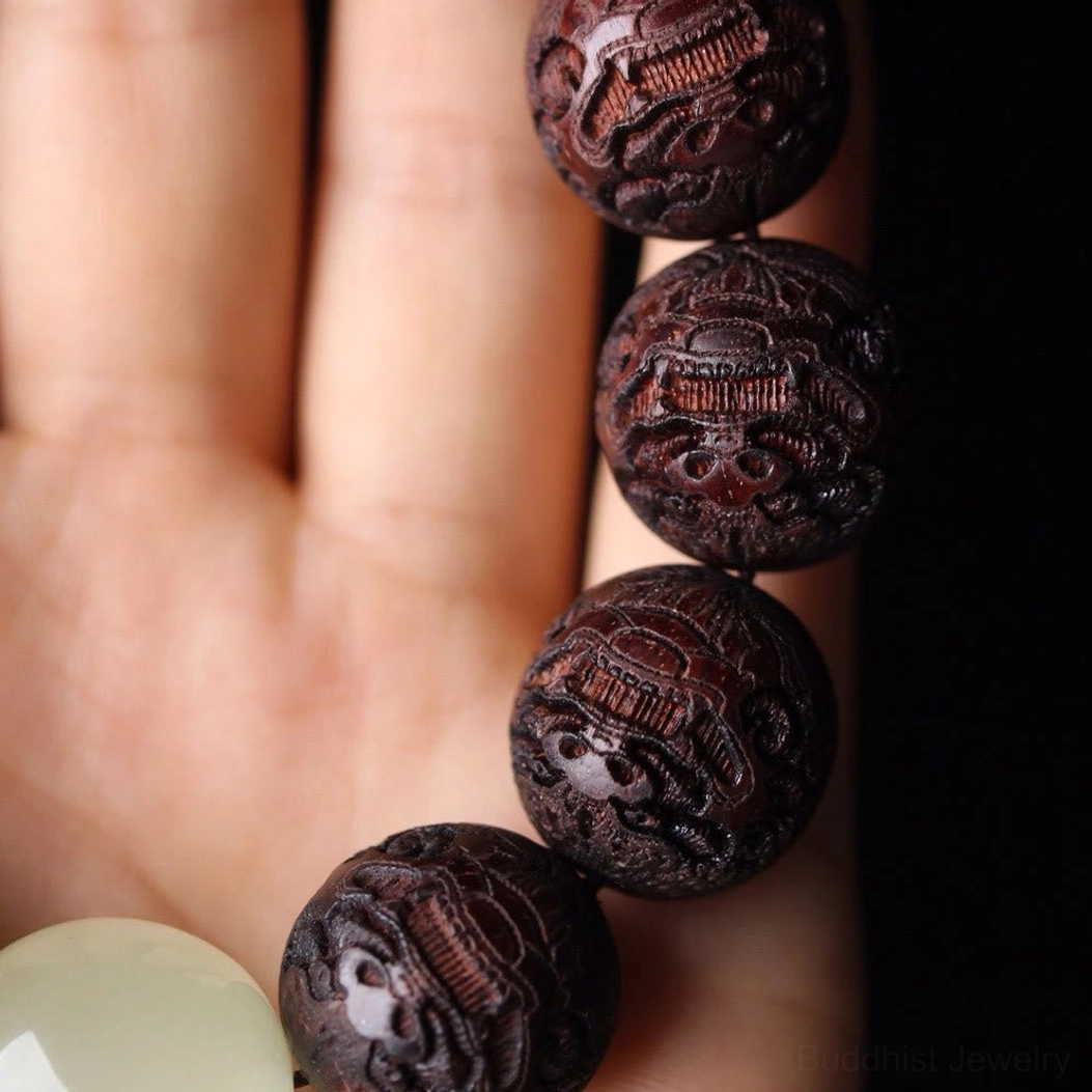 Rosewood Pixiu Buddhist bracelet on palm showing side overhead angle with multiple beads