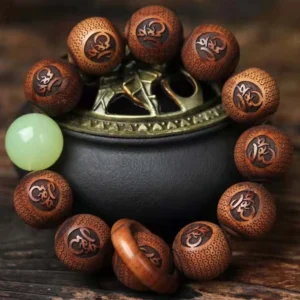 Rosewood Buddhist tiger engraved bracelet close-up with sacred censer, showing detailed tiger motifs and carved script beads with jade spacer
