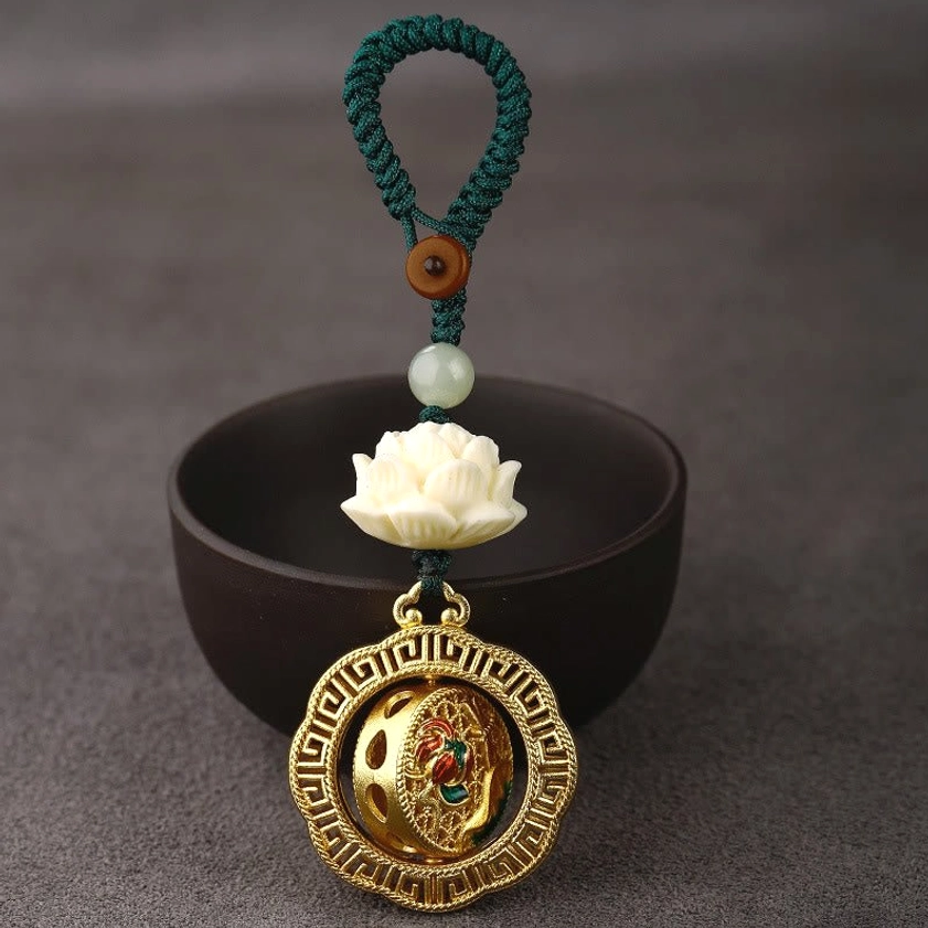 Rotatable copper peace keychain with plain embossed pendant, bodhi seed and jade components with green braided lanyard