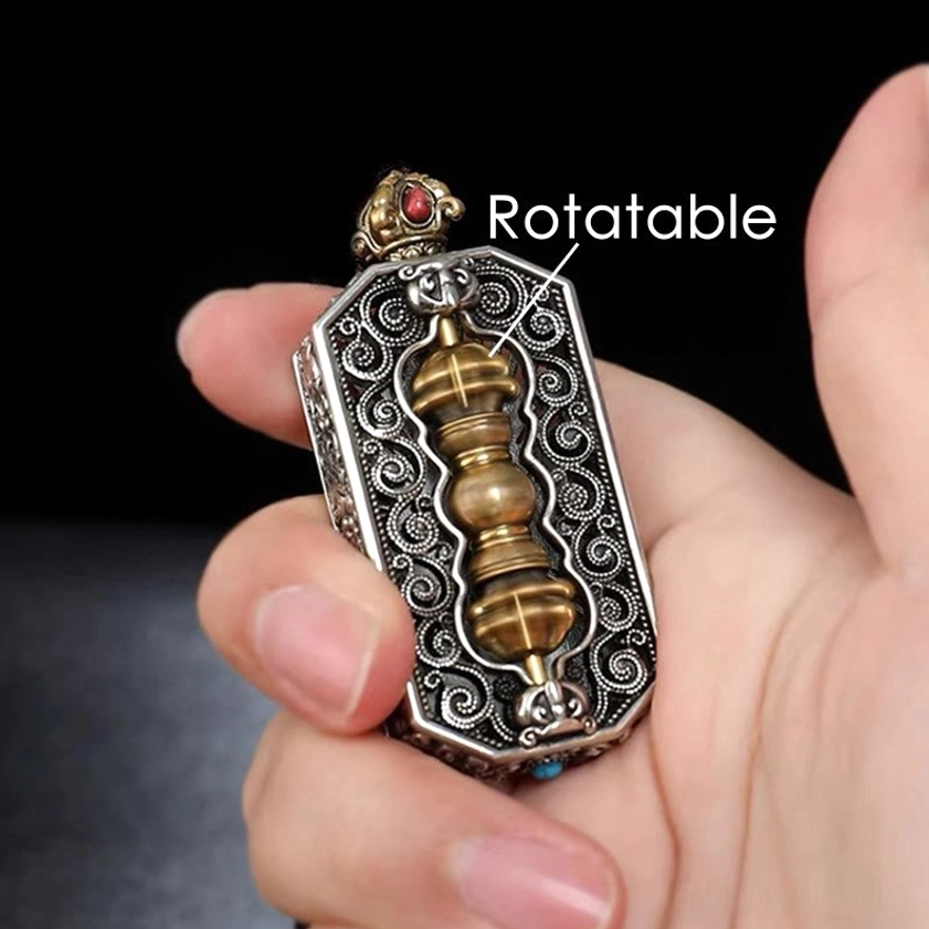 Close-up rotatable dorje vajra center mechanism on om mani padme hum pendant necklace held in hand