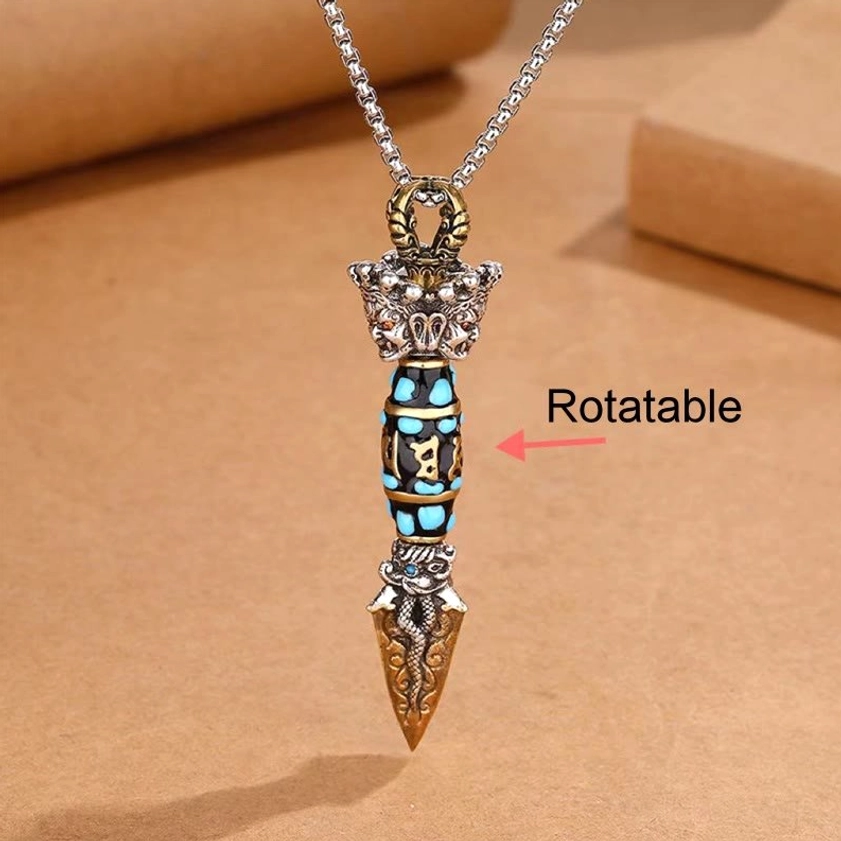 Rotatable dzi bead Buddhist dorje pendant necklace top view, Om Mani Padme Hum mantra inlay detail, turquoise accents and rotating center bead mechanism
