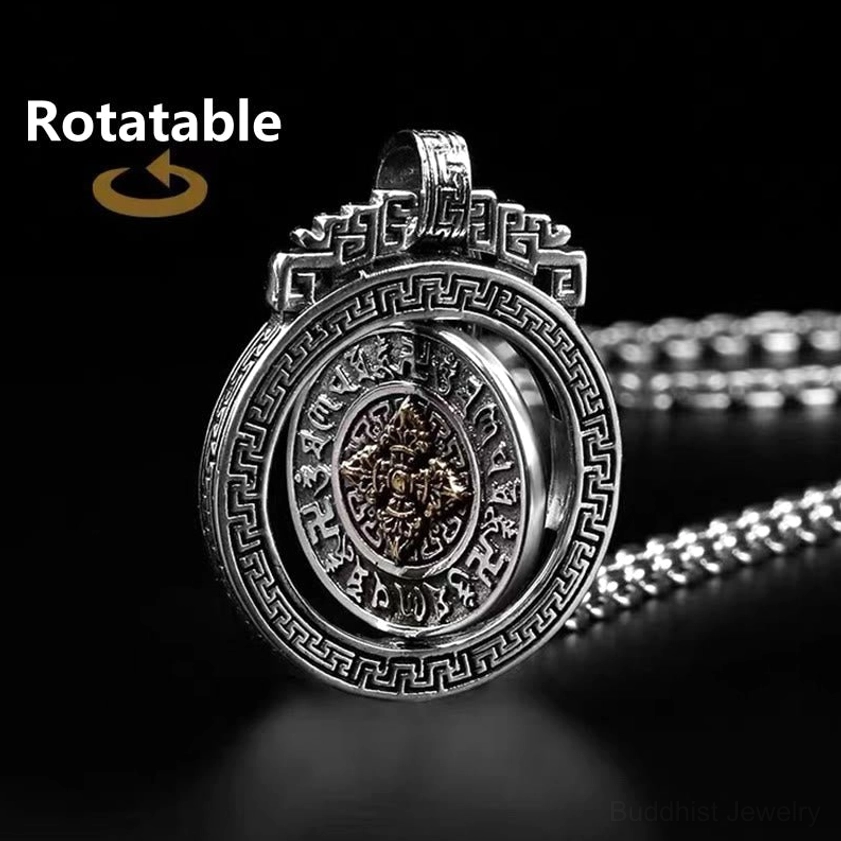 Rotatable mandala Buddhist pendant with engraved fretwork border and inner spinning disc oblique view