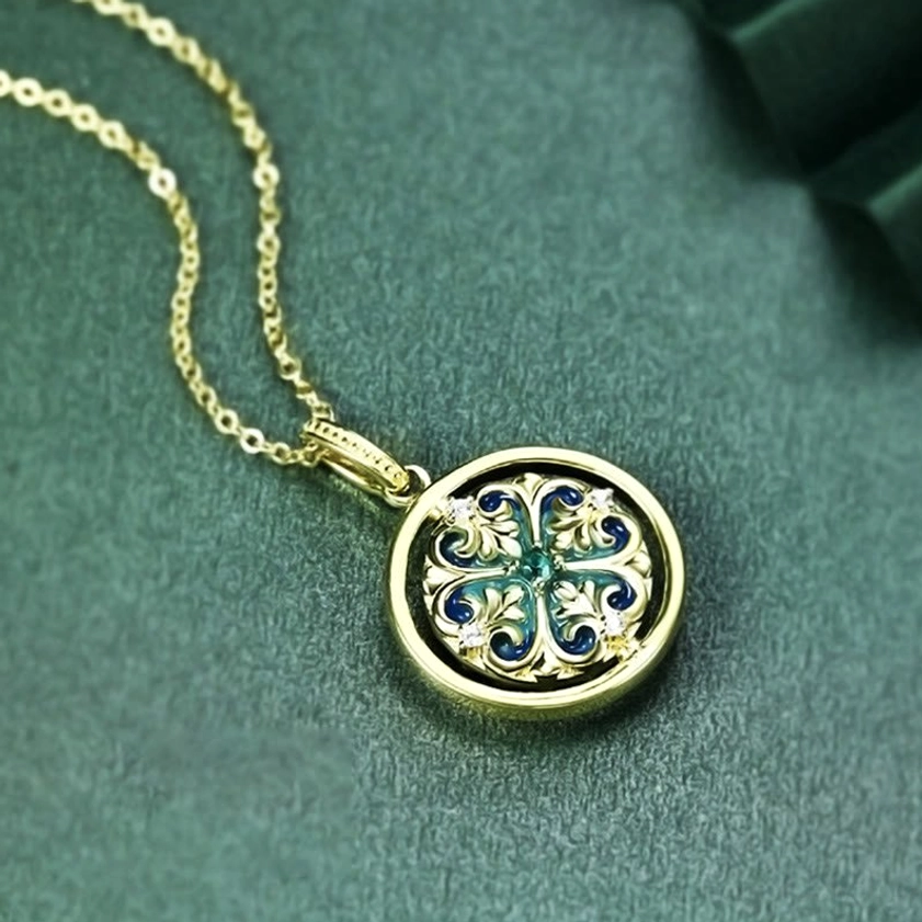 Rotatable necklace pendant with gold chain attachment, side angle view showing cross pattern