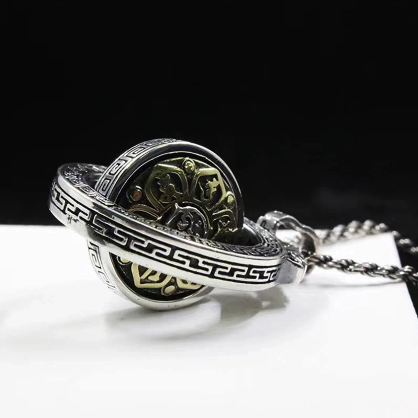 Rotatable Buddhist necklace pendant side view demonstrating hollow frame with spinning inner disc mechanism