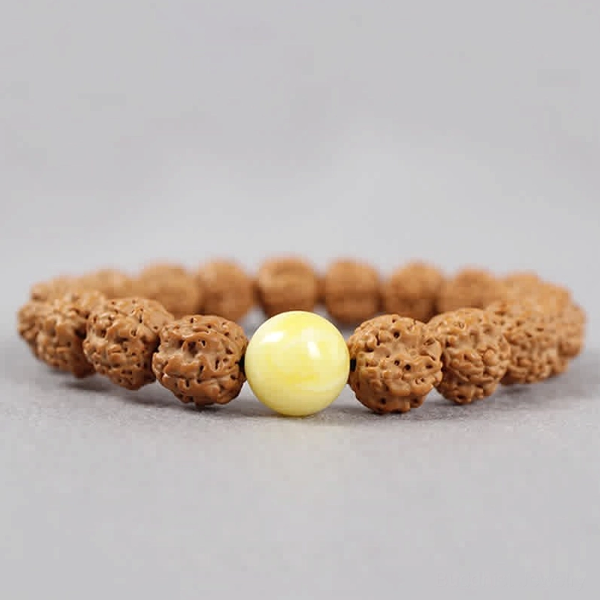 Rudraksha Bodhi Seed and Amber bracelet top down view showing natural textured brown seeds with round yellow amber accent bead