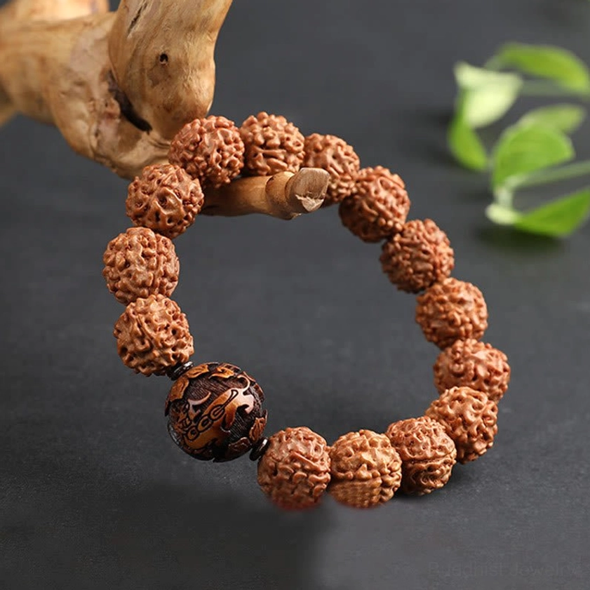 Rudraksha Bodhi seed bracelet side view wooden driftwood leaves background prosperity protection