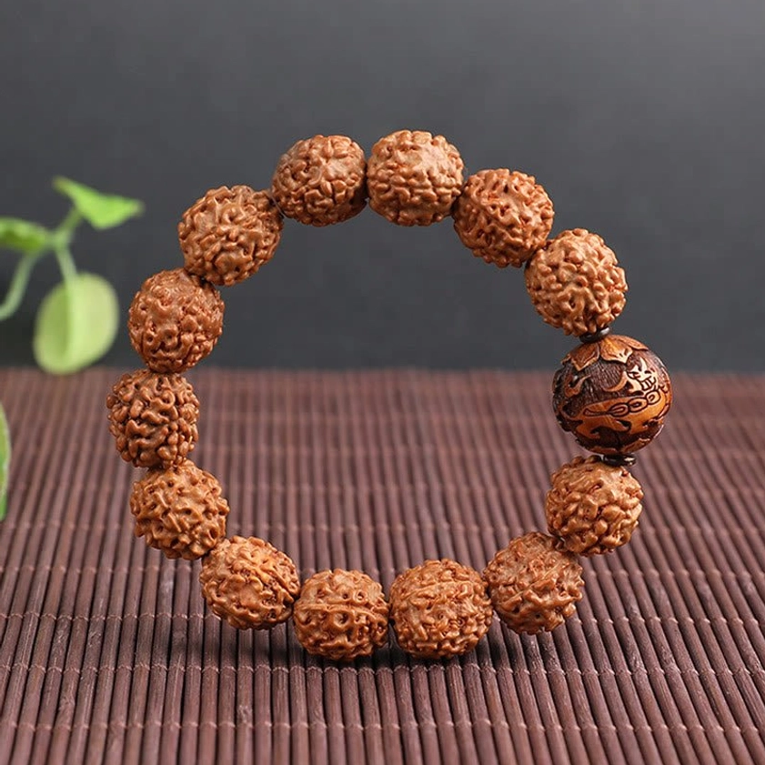 Meditation Rudraksha bracelet flat lay side view bamboo mat green leaves earthy brown beads feng shui