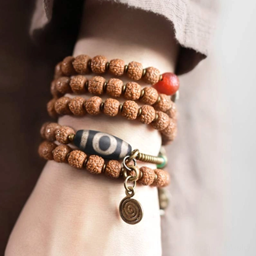 108 Rudraksha Mala Bracelet Worn on Wrist - Stacked Prayer Beads with Dzi Bead Close-Up