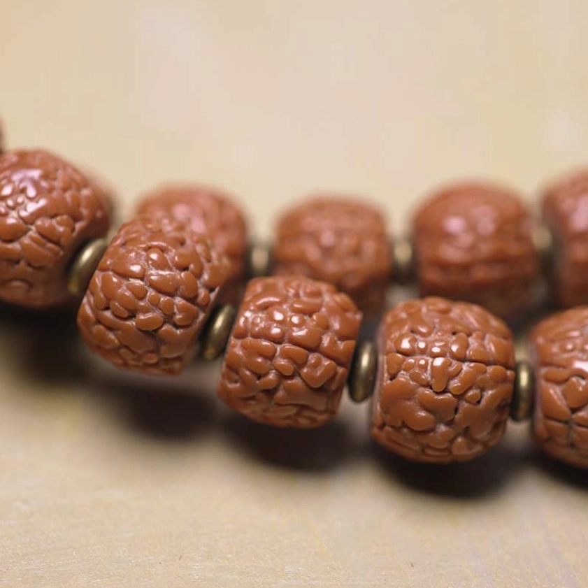 Textured Rudraksha Seeds Close-Up - Natural Brown Buddhist Prayer Beads with Metal Rings